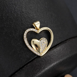 Macro shot of 18K gold plated heart pendant with micro-inlaid sparkling zircon details