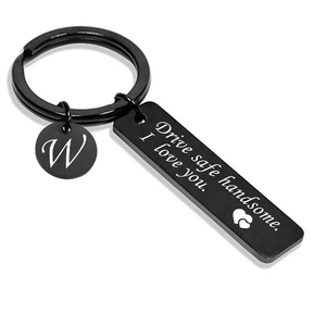 Detail of black metal Drive Safe Handsome keychain with engraved letter W pendant