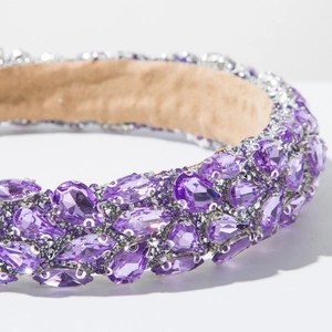 Detail of luxurious baroque headband featuring purple teardrop rhinestones and velvet lining