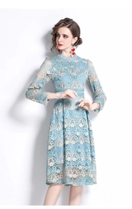 Close-up of blue floral lace embroidery detail and fine texture on the long sleeve dress