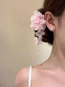 Detail of pink fabric flower hair clip with pearls and elegant water drop tassel pendant