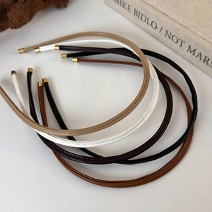 Minimalist slim leather headbands in five colors with gold ends and stitching detail