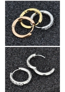 Detailed view of silver, gold and rose gold CZ inlaid huggie hoops on black texture