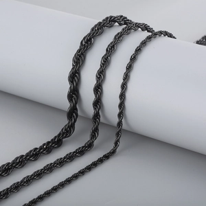 Three black stainless steel twist chains in varying thickness on a white pedestal