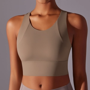 Detail of dark khaki yoga sports bra showing wide shoulder straps and supportive hem