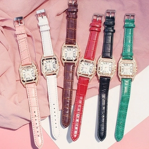 Detailed flat lay of square quartz watches with rhinestone bezels and multi-color straps