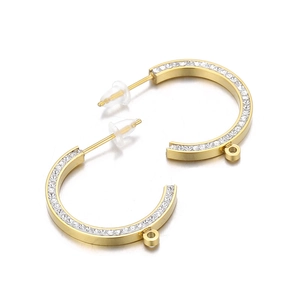 Gold C-shaped stainless steel earrings with crystal pavé and small charm hanging loops