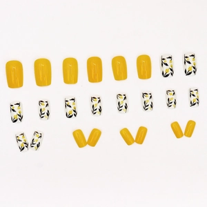 Short square-oval ginger yellow press-on nails with white floral and leaf silhouettes