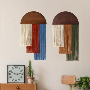 Nordic wall hanging with wood and colorful cotton tassels in a cozy home setting