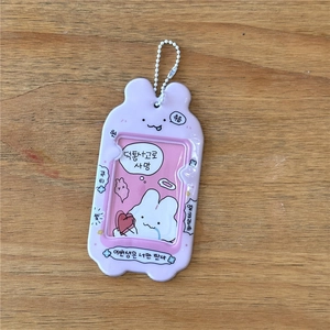 Macro view of light purple cartoon bunny photo holder with white bead chain and insert
