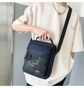 Detail of multi-functional crossbody bag in navy blue and camouflage pattern