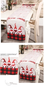 Detail of Christmas table runner featuring festive gnomes and Merry Christmas text print