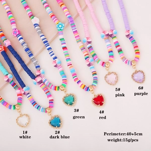 Detailed view of bohemian clay disc necklaces with assorted colorful heart pendants
