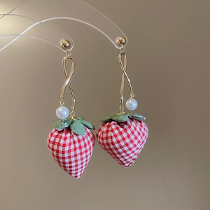 Detail of strawberry drop earrings with red gingham fabric and white pearl accents