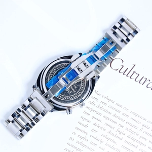 Close-up of the stainless steel case back and link strap of a men's fashion watch.
