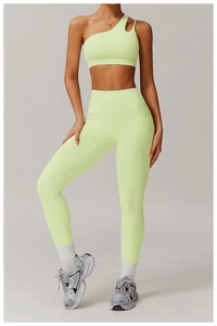 Detail of high waist yoga pants side pocket and asymmetric neon sports bra set
