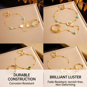 Detail of four gold slave bracelets with turquoise clover, butterfly and tree of life charms