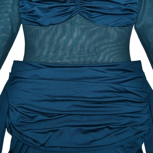 Detailed close-up of peacock blue ruched fabric and sheer mesh splicing on a slim dress