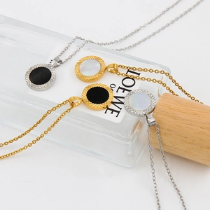 Minimalist stainless steel necklaces with round shell pendants on elegant display stands