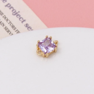 Macro shot of purple faceted square zircon pendant with gold double-loop connectors