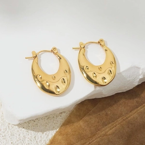 Detailed macro view of 18K gold-plated chunky hoop earrings with teardrop textured design