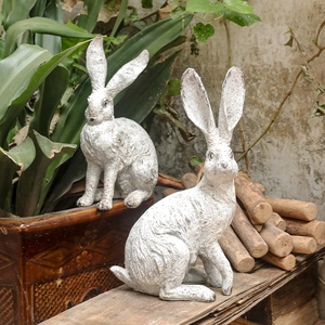 Set of two vintage rustic rabbit garden statues with distressed white finish for outdoor decor