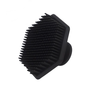 Hexagonal black silicone facial cleansing brush with soft bristles and ergonomic handle