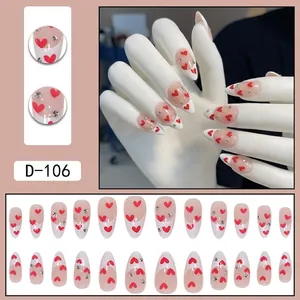 French white almond press-on nails with red heart patterns and small rhinestones