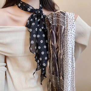 Detail of elegant polka dot and animal print silk scarf necklaces for women
