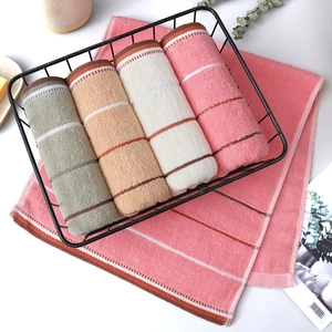 Detailed view of Morandi-colored cotton towels with soft terry texture in a storage basket