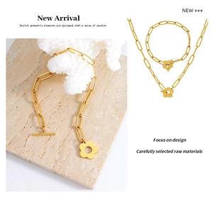 Macro detail of vintage gold OT toggle chunky chain necklace and bracelet with plum blossom