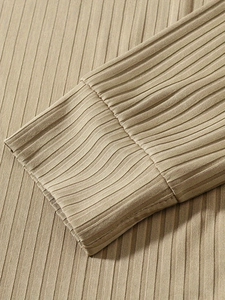 Detailed close-up of ribbed cuffs on a khaki vertical striped long sleeve polo shirt