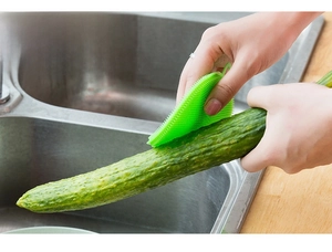 Macro detail of flexible green silicone brush bristles for cleaning fresh cucumbers