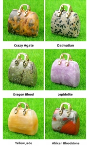 Macro detail of six mini crystal handbag pendants made of natural polished gemstones