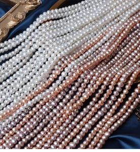 Macro detail of high-quality 5mm natural freshwater pearls in white, purple and pink tones