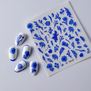 Macro detail of 5D blue flower nail stickers with embossed texture on white nails
