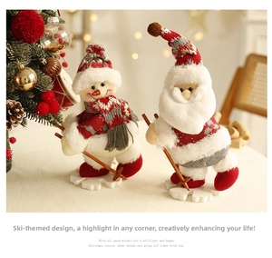 Detail of Santa Claus and Snowman plush skiing figurines for festive Christmas decor