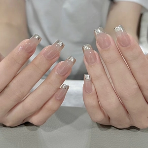 Short square nude French press-on nails with shiny silver tips for a modern elegant look