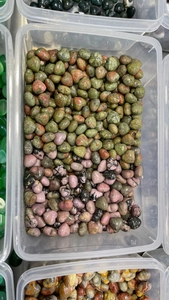 Bulk polished heart-shaped crystals in unakite and rhodonite stored in clear containers