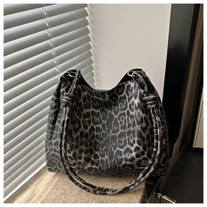 Detail view of large leopard print tote bag with soft PU leather texture and light shadows
