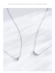 Macro shot of 925 sterling silver necklaces featuring triangular and curved diamond pendants