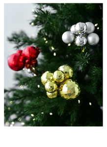 Close-up of diamond-cut Christmas ball ornaments in red, gold and silver on a tree