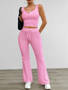 Detail of pink sleeveless V-neck button top and matching drawstring flared yoga pants