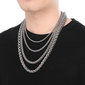Close-up of layered stainless steel cable chains on model for professional fashion display