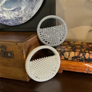 Exquisite hand-woven beaded handbags in white pearl and silver rhinestone finishes