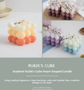 Macro view of gradient heart-shaped cube scented candles with elegant ribbon detail
