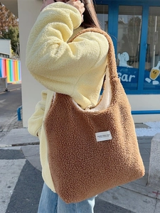 Brown fleece tote bag with white lining shown in a bright outdoor autumn street setting