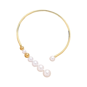 Elegant gold open bangle with white pearls and beads on a clean white background