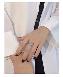 Close-up of S925 silver open ring featuring a geometric round design with star engraving