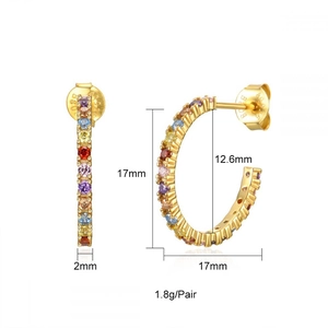 Macro view of gold hoop earrings with colorful rainbow cubic zirconia stones